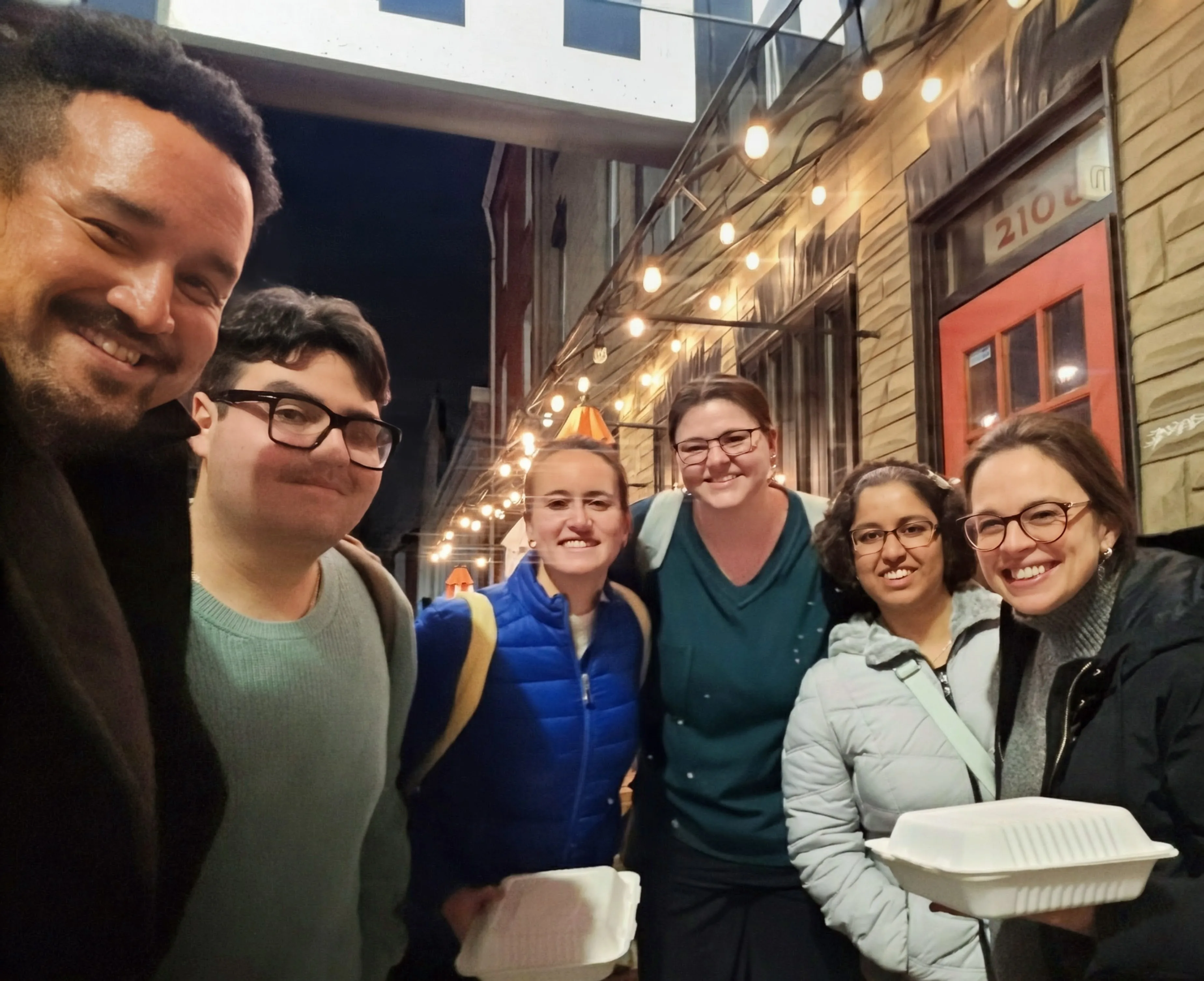 Lab team enjoying pizza together at Johnny Rad's restaurant