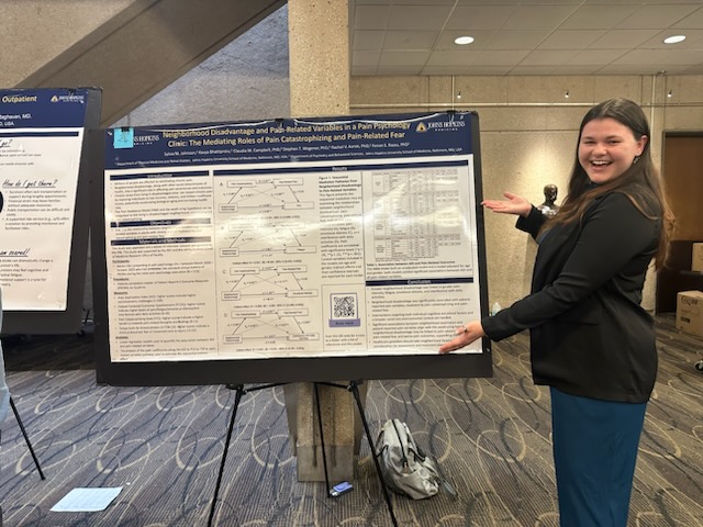 Sylvia Johnson standing beside her award-winning research poster at the PM&R Research and Clinical Expo